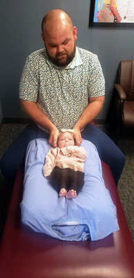 Chiropractor Erie PA Ian West Adjusting Baby